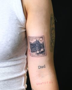 A detailed One Pillar Pagoda tattoo on a client's arm, showcasing traditional Vietnamese architecture.